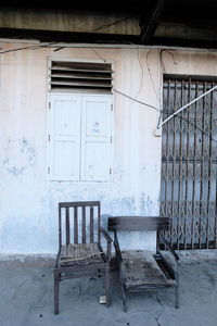 Empty chairs and table in abandoned building