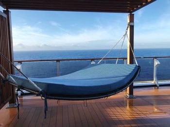 Swimming pool by sea against sky