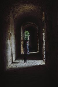 Rear view of woman walking in corridor