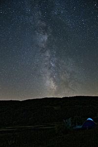 Scenic view of landscape against star field