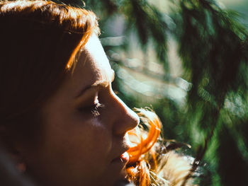 Close-up portrait of young woman with eyes closed