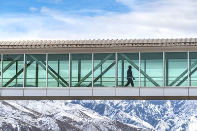 People on snow covered mountain against sky