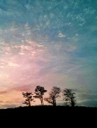 Silhouette trees against sky during sunset