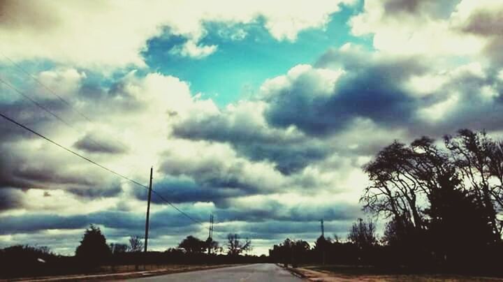 VIEW OF ROAD AGAINST CLOUDY SKY