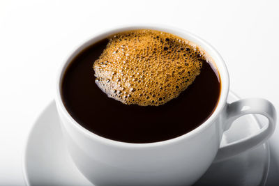 High angle view of coffee cup against white background