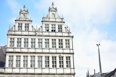 Low angle view of historical building against cloudy sky