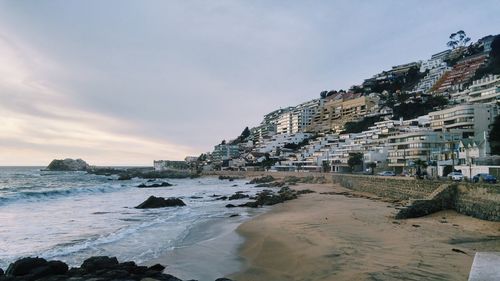 Scenic view of beach by sea against sky
