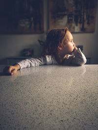 Girl looking away while sitting at home