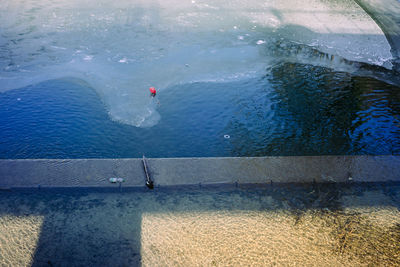 Man swimming in sea against sky