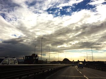 Road passing through dramatic sky