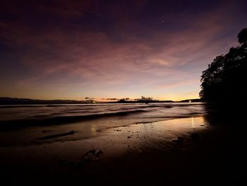 Scenic view of beach against sky during sunset