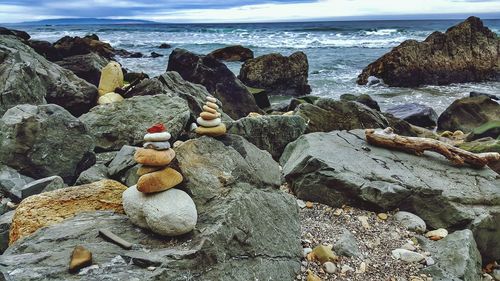 Close-up of stones on beach against sky