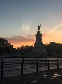 Statue against sky at sunset