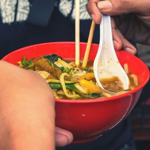 Close-up of hand holding salad