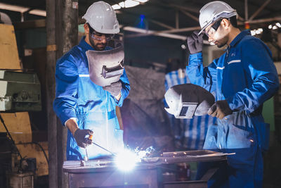 Rear view of man working at construction site