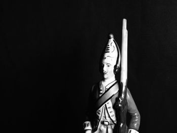 Porcelin soldier against black background