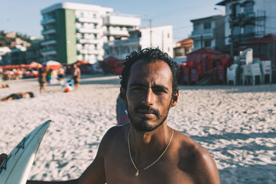 Close-up of shirtless man at beach against sky