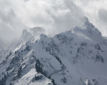 Scenic view of snow covered mountains against sky