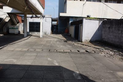 Footpath amidst buildings in city