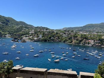 High angle view of townscape by sea against sky