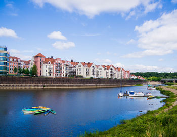 Boats in river against sky