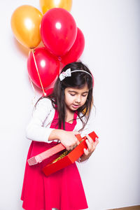 Portrait of girl holding balloons