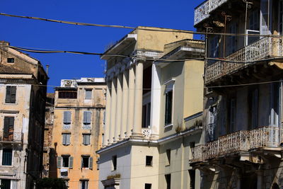 Low angle view of buildings against clear blue sky