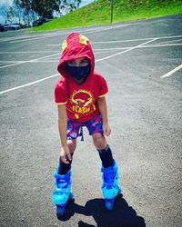 Full length of boy standing on road