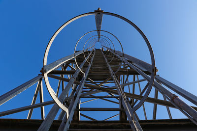 Low angle view of metallic structure against clear blue sky