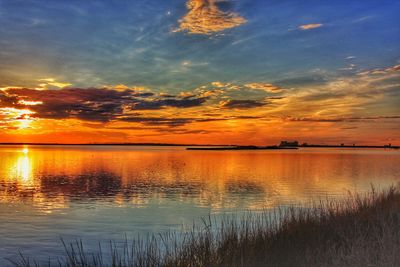 Scenic view of lake against dramatic sky