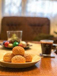 Close-up of crispy cream puffs in plate on table