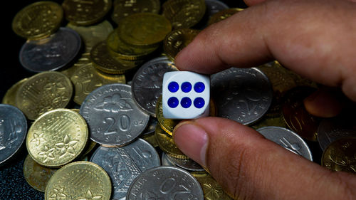 Close-up of hand holding coins