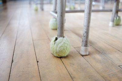 Tennis balls on student desk legs in empty classroom, naoshima, japan