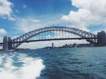 View of bridge over sea against cloudy sky