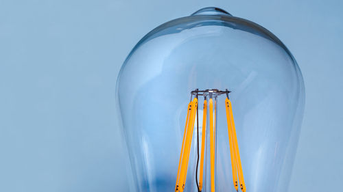 Low angle view of lighting equipment against blue sky