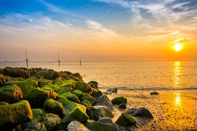 Scenic view of sea against sky during sunset