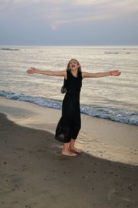 Full length of girl standing on beach