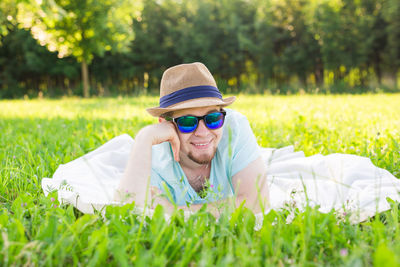 Portrait of smiling man lying down on grass