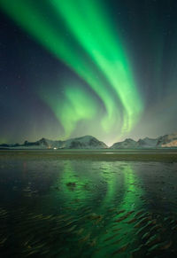 Scenic view of snowcapped mountains against sky at night