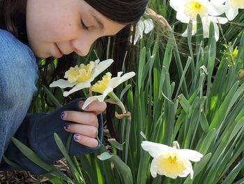 Midsection of woman holding yellow flowering plants