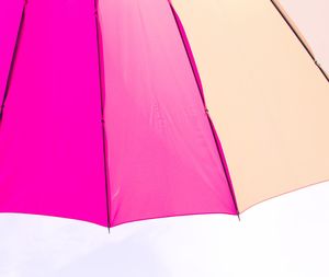 Low angle view of multi colored umbrella against sky