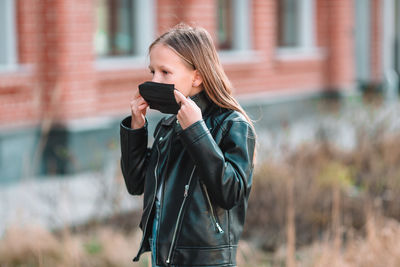Young woman photographing with mobile phone