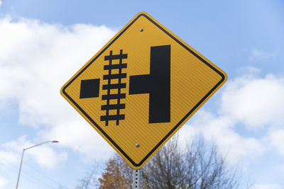 Low angle view of road sign against sky