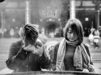 Women looking at city in park