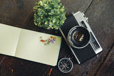 Camera with papers and potted plant