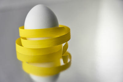 Close-up of yellow cup on table