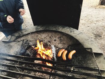 High angle view of man cooking on barbecue grill