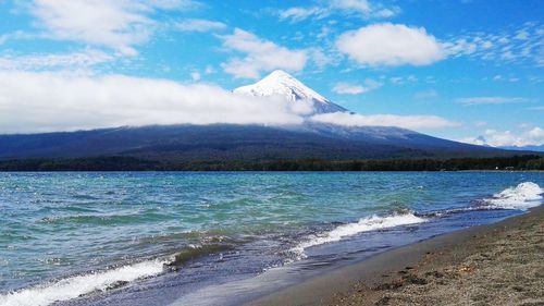 Scenic view of mountains against cloudy sky