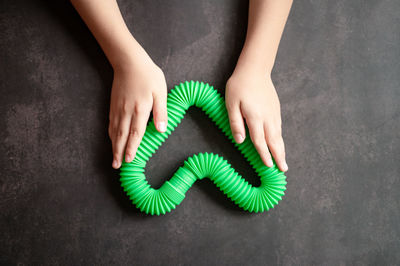 Anti stress sensory pop tube toys in a children's hands. a little kids plays with a poptube toy