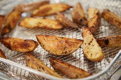 Potato fries on a cooiling grid close up